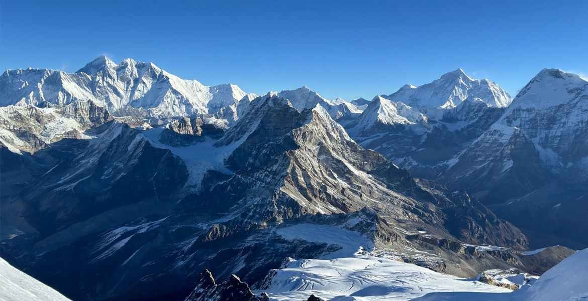 Makalu, Lhotse, Everest, and Nuptse highest mountains views with other tall snow-capped peaks from the Mera peak summit.